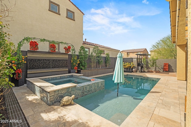 view of pool featuring a patio area, a fenced backyard, and a pool with connected hot tub