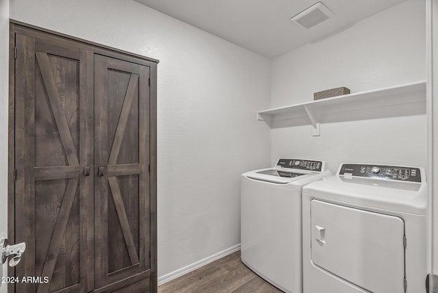 laundry area featuring dark hardwood / wood-style floors and washing machine and clothes dryer