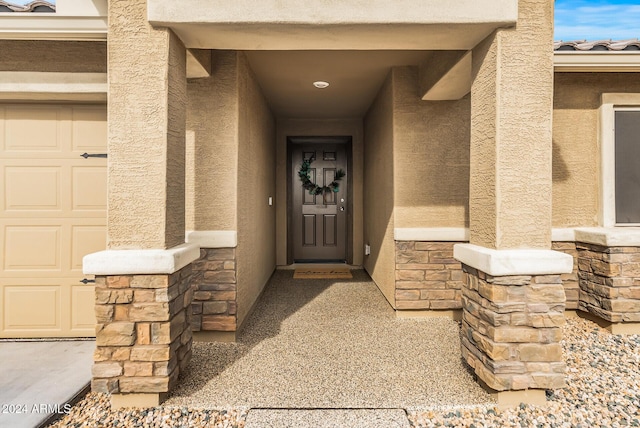 doorway to property with a garage