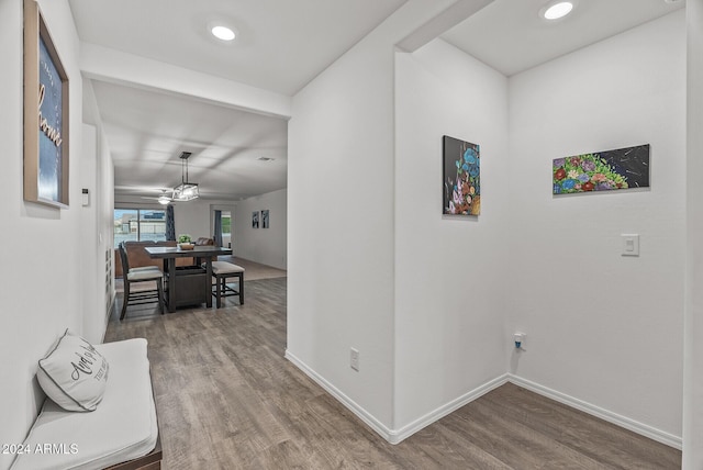 hallway with hardwood / wood-style floors