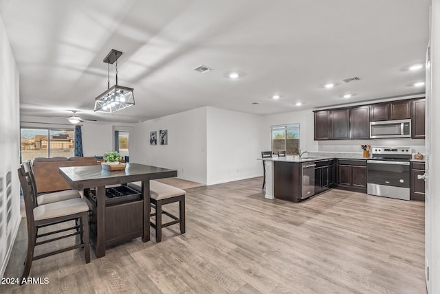 dining room with light hardwood / wood-style flooring, ceiling fan, and sink