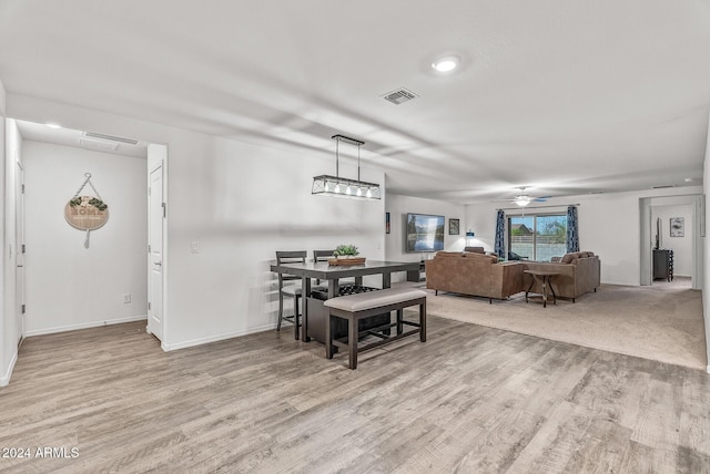 dining area with ceiling fan and light hardwood / wood-style flooring