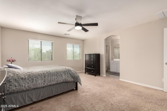 125 N Sunvalley Blvd Unit 119, Mesa, AZ 85207 - bedroom featuring light carpet, arched walkways, ensuite bathroom, and ceiling fan