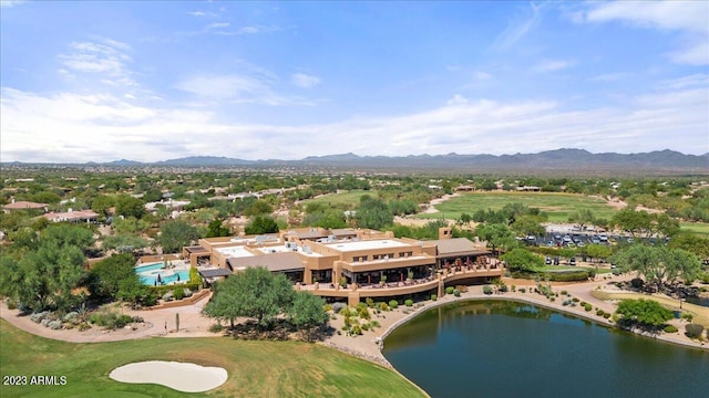 birds eye view of property with a water and mountain view