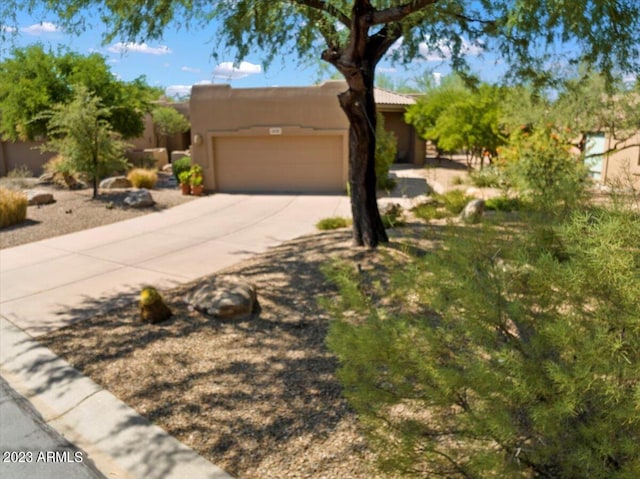 pueblo-style home featuring a garage