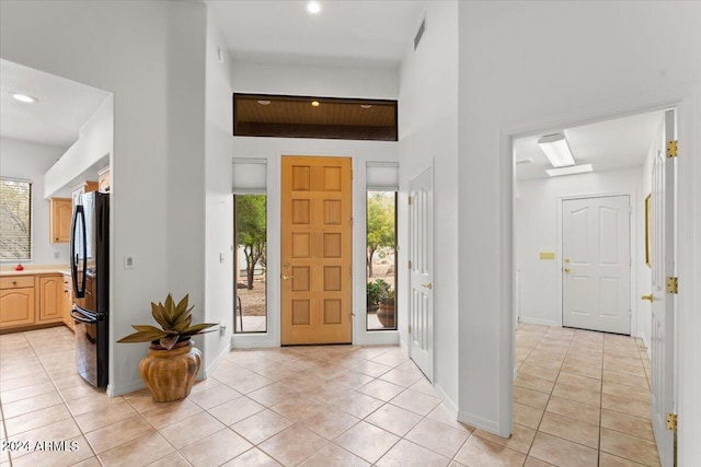 foyer entrance with light tile patterned floors