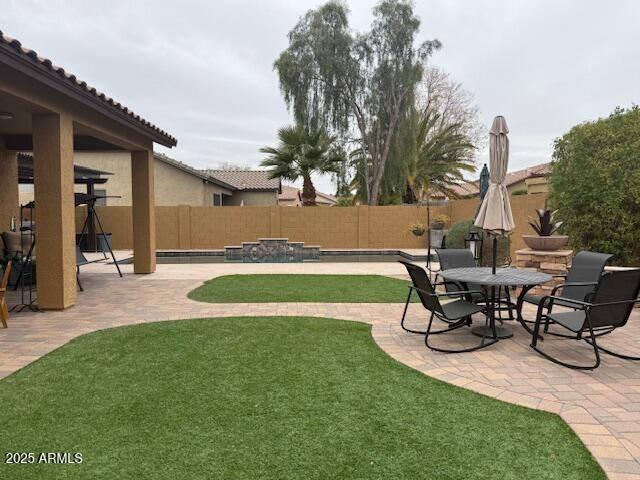 view of yard featuring a patio area and a fenced backyard