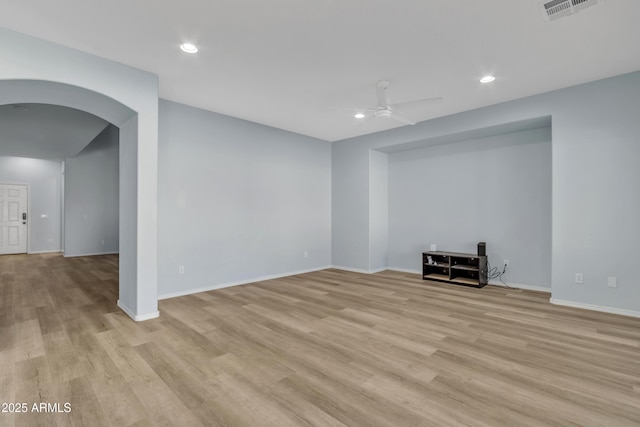 unfurnished living room with ceiling fan and light hardwood / wood-style flooring