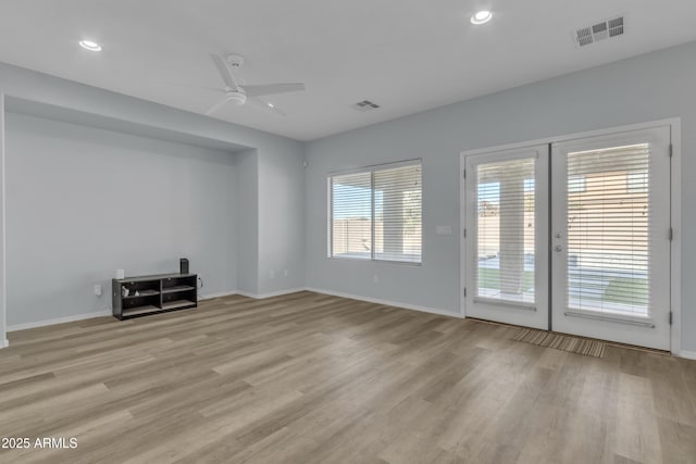 unfurnished living room with french doors, light hardwood / wood-style flooring, and ceiling fan