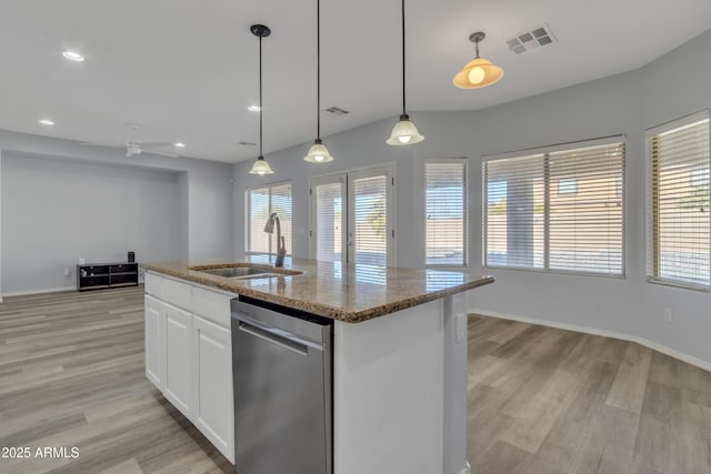 kitchen featuring white cabinetry, sink, stainless steel dishwasher, decorative light fixtures, and a center island with sink