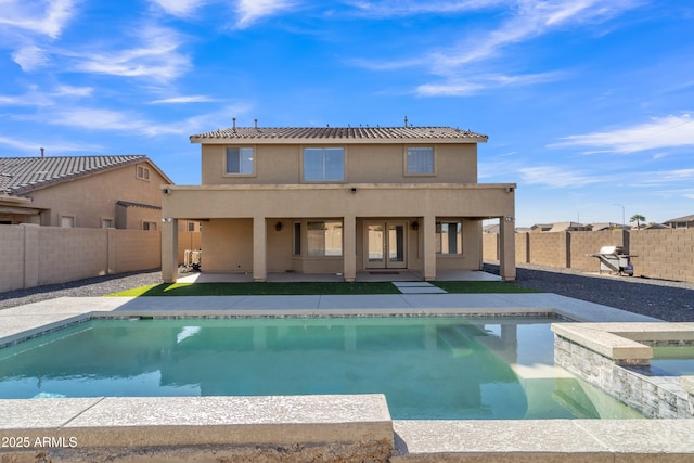 back of property featuring a fenced in pool and a patio area