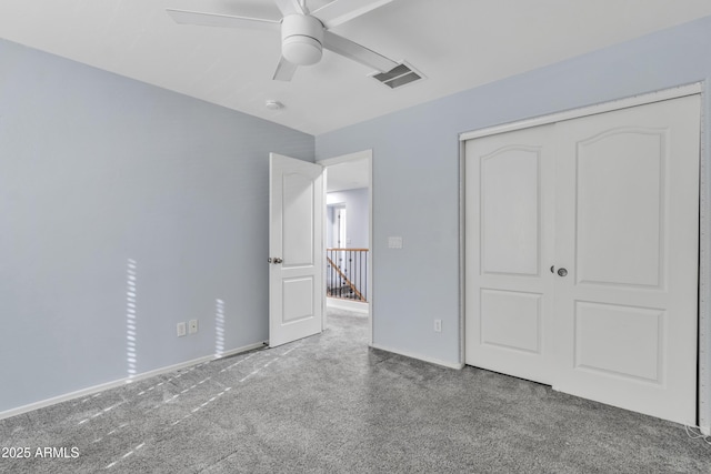 unfurnished bedroom with carpet flooring, ceiling fan, and a closet