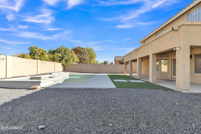 view of yard with a patio area and a fenced in pool