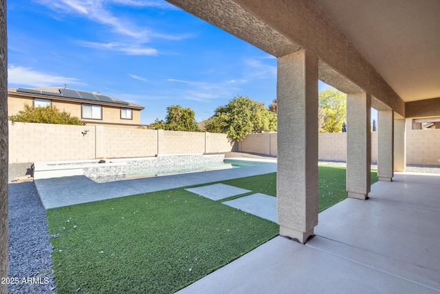 view of yard featuring a patio area and a fenced in pool