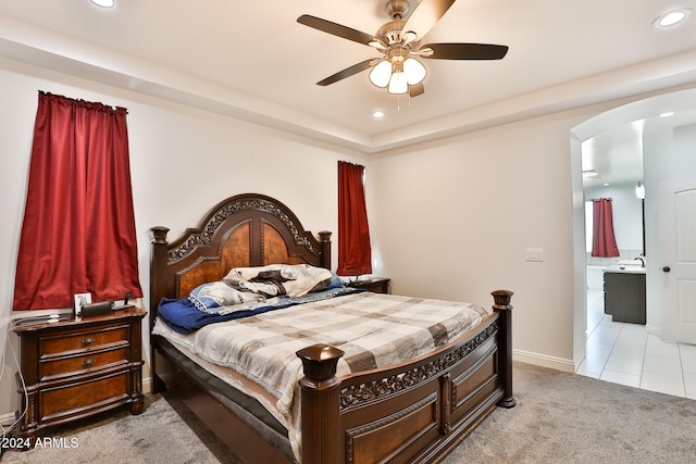 carpeted bedroom with ceiling fan and sink