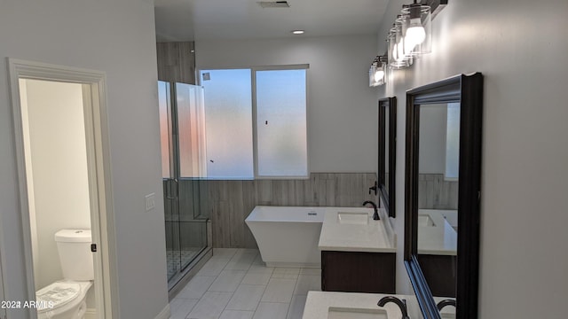 full bathroom with vanity, tile walls, plus walk in shower, tile patterned flooring, and toilet