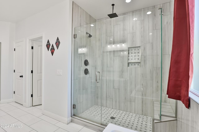 bathroom with tile patterned floors and a shower with shower door