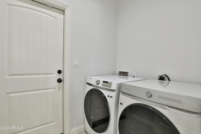 clothes washing area with separate washer and dryer