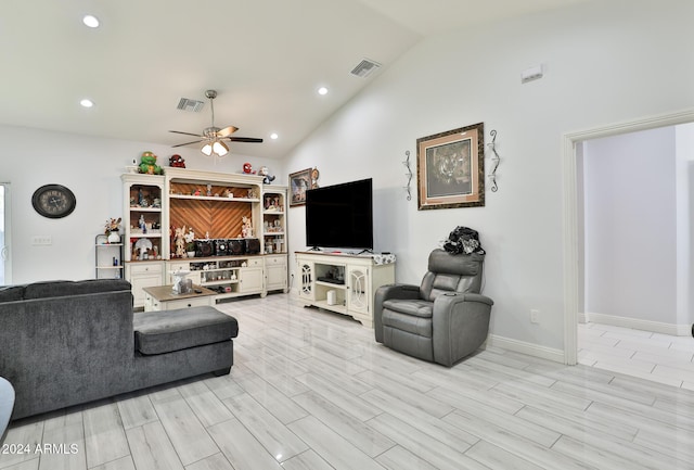 living room with ceiling fan, high vaulted ceiling, and light hardwood / wood-style floors