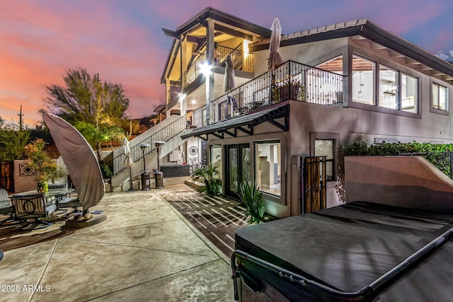 36723 N 33rd Ave, Phoenix, AZ 85086 - back of property at dusk with a patio, stairway, and stucco siding