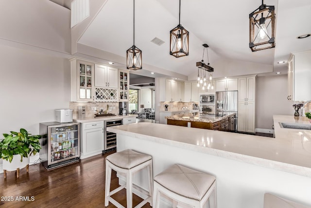 36723 N 33rd Ave, Phoenix, AZ 85086 - kitchen with wine cooler, a sink, appliances with stainless steel finishes, dark wood-style floors, and visible vents