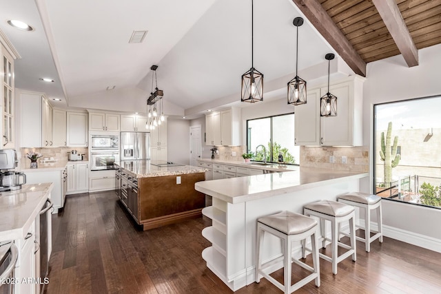 36723 N 33rd Ave, Phoenix, AZ 85086 - kitchen with lofted ceiling with beams, white cabinets, and stainless steel appliances