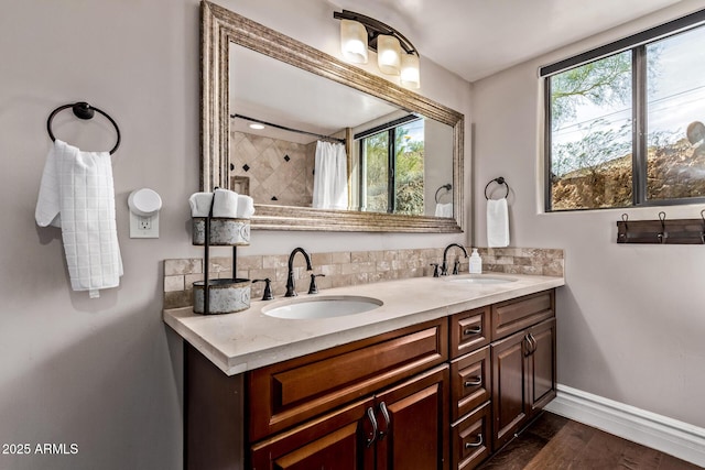 36723 N 33rd Ave, Phoenix, AZ 85086 - full bath with baseboards, a sink, wood finished floors, and tasteful backsplash