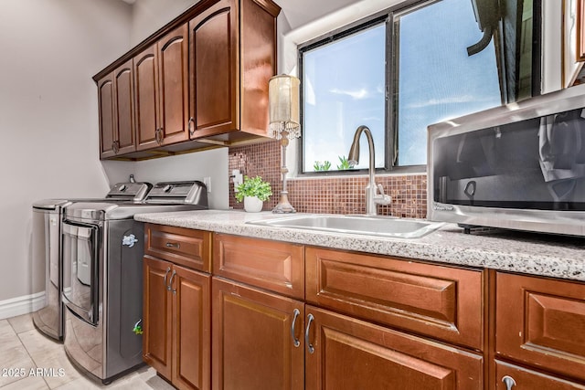 36723 N 33rd Ave, Phoenix, AZ 85086 - washroom featuring a sink, washing machine and clothes dryer, light tile patterned floors, baseboards, and cabinet space