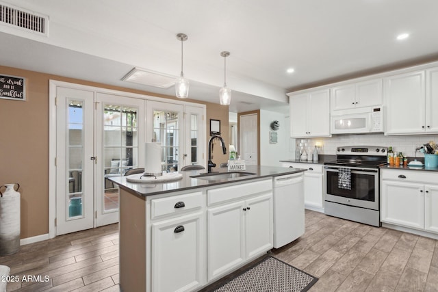 5154 N 83rd St, Scottsdale, AZ 85250 - kitchen with white appliances, a sink, dark countertops, light wood-type flooring, and french doors