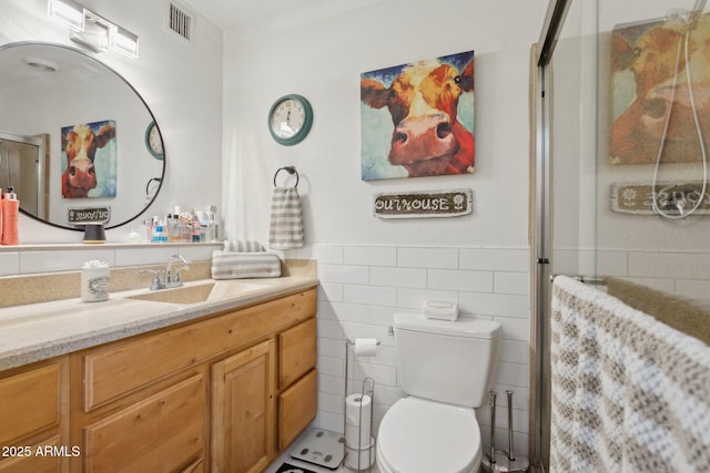 5154 N 83rd St, Scottsdale, AZ 85250 - bathroom featuring vanity, tile walls, a stall shower, toilet, and a wainscoted wall