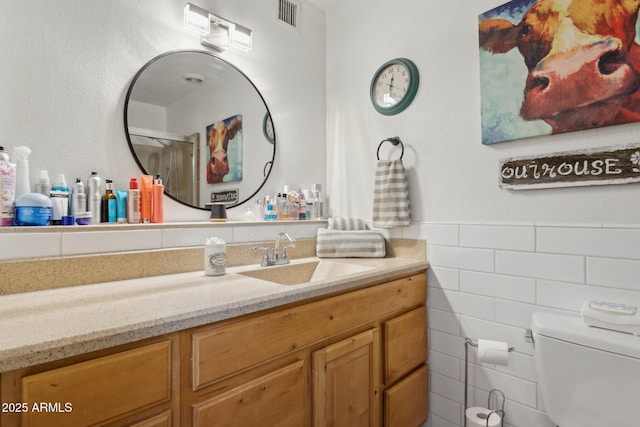 5154 N 83rd St, Scottsdale, AZ 85250 - bathroom featuring toilet, vanity, tile walls, and a shower with shower door