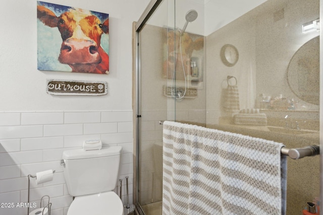 5154 N 83rd St, Scottsdale, AZ 85250 - full bath with a shower stall, toilet, tile walls, and a wainscoted wall