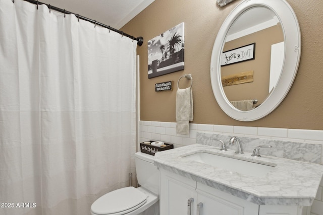 5154 N 83rd St, Scottsdale, AZ 85250 - full bathroom with toilet, vanity, tile walls, wainscoting, and a shower with curtain