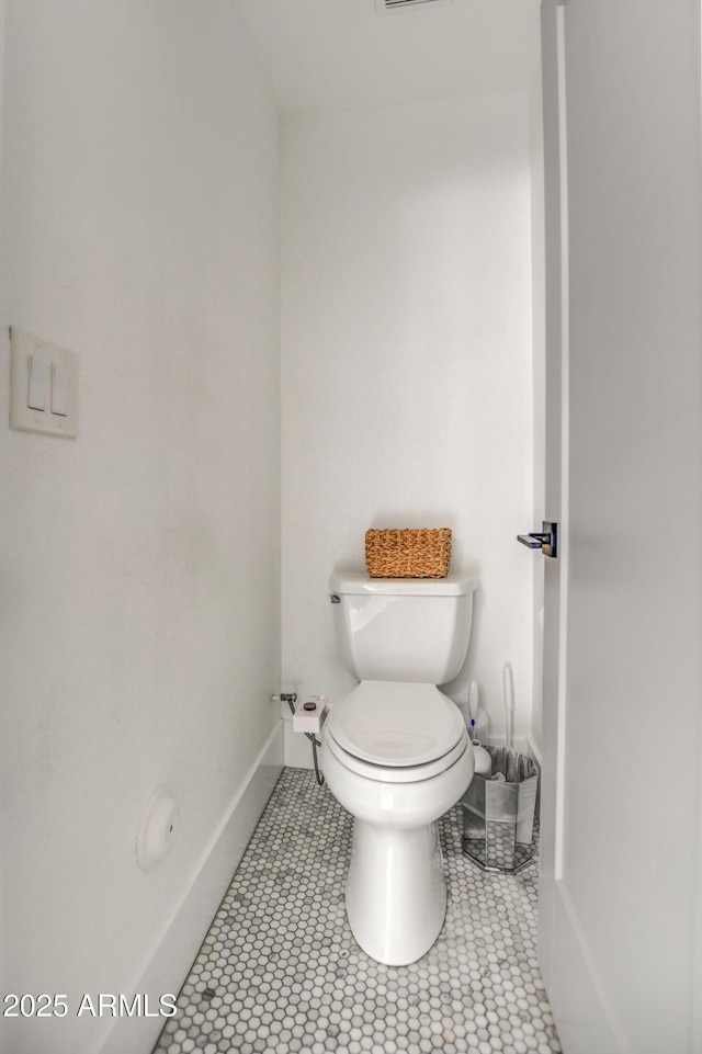 bathroom with tile patterned flooring and toilet