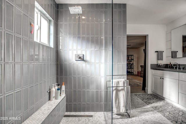 bathroom featuring walk in shower and vanity