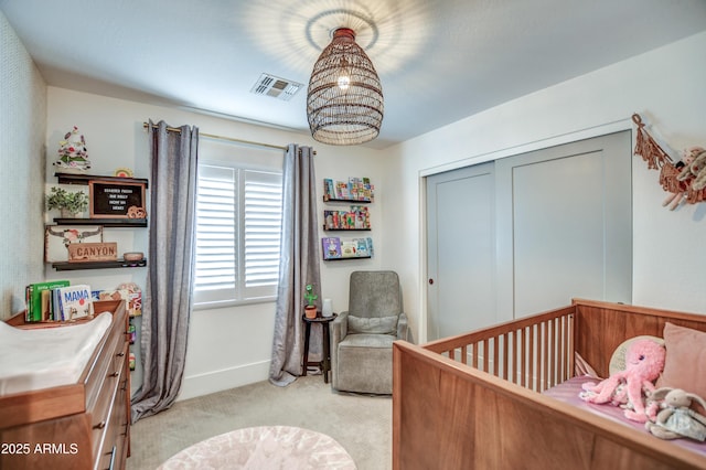 bedroom with a nursery area and light carpet