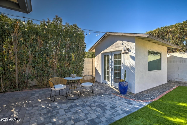 view of patio / terrace featuring an outbuilding and french doors