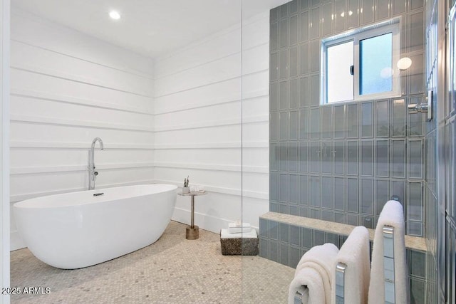 bathroom with tile patterned flooring and a bathing tub