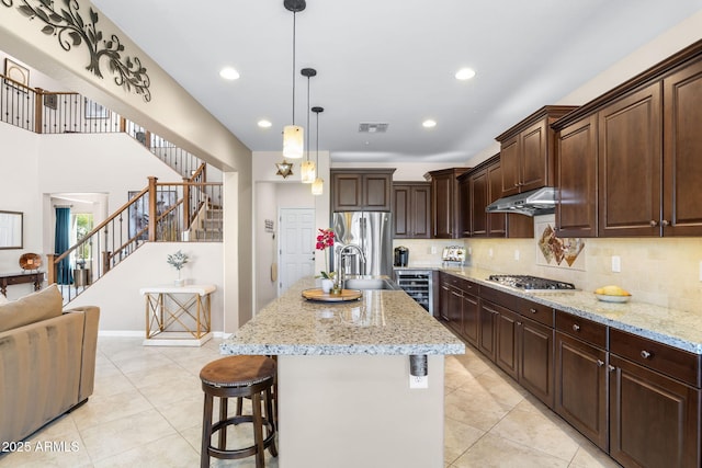 31156 N 137th Ln, Peoria, AZ 85383 - kitchen featuring light tile patterned floors, stainless steel appliances, light stone countertops, a sink, and backsplash