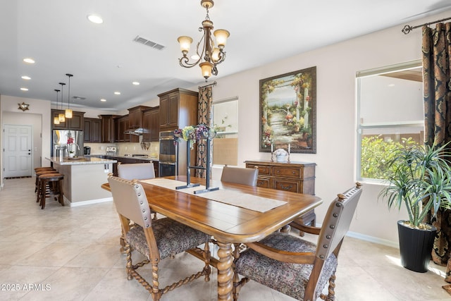 31156 N 137th Ln, Peoria, AZ 85383 - dining space with light tile patterned floors, a chandelier, recessed lighting, and baseboards