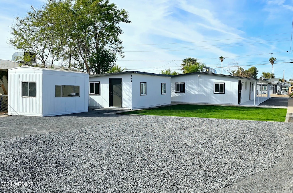 rear view of property with a lawn