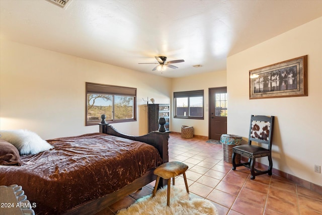 bedroom with ceiling fan and light tile patterned floors