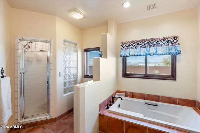 bathroom featuring tile patterned floors and separate shower and tub