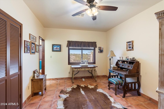 tiled office featuring ceiling fan