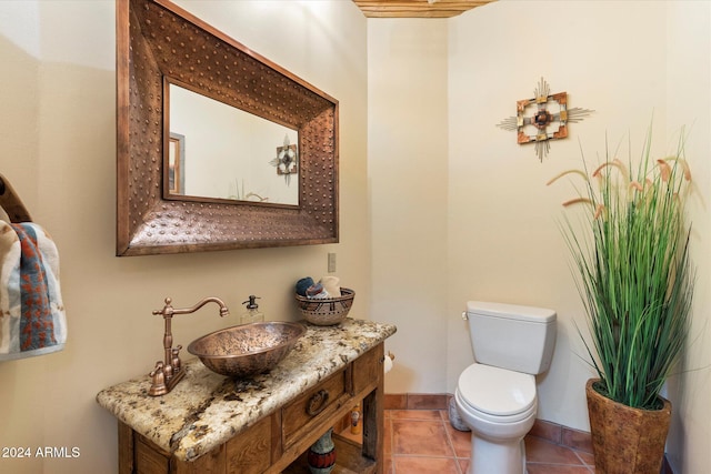 bathroom with tile patterned floors, vanity, and toilet