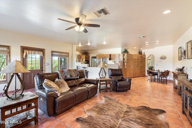 living room featuring ceiling fan and light tile patterned flooring