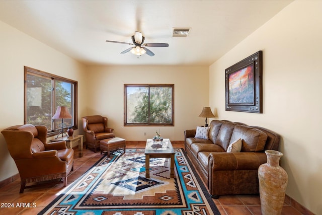 living room featuring tile patterned flooring, ceiling fan, and a healthy amount of sunlight