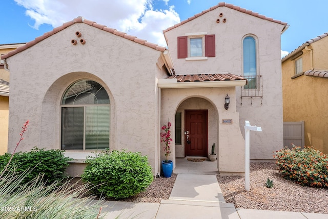 view of front of house with a tile roof and stucco siding