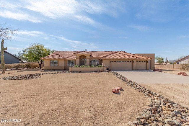 mediterranean / spanish-style home featuring concrete driveway, a tile roof, and stucco siding