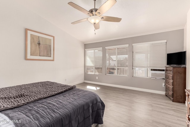 bedroom with vaulted ceiling, baseboards, cooling unit, and light wood-style floors